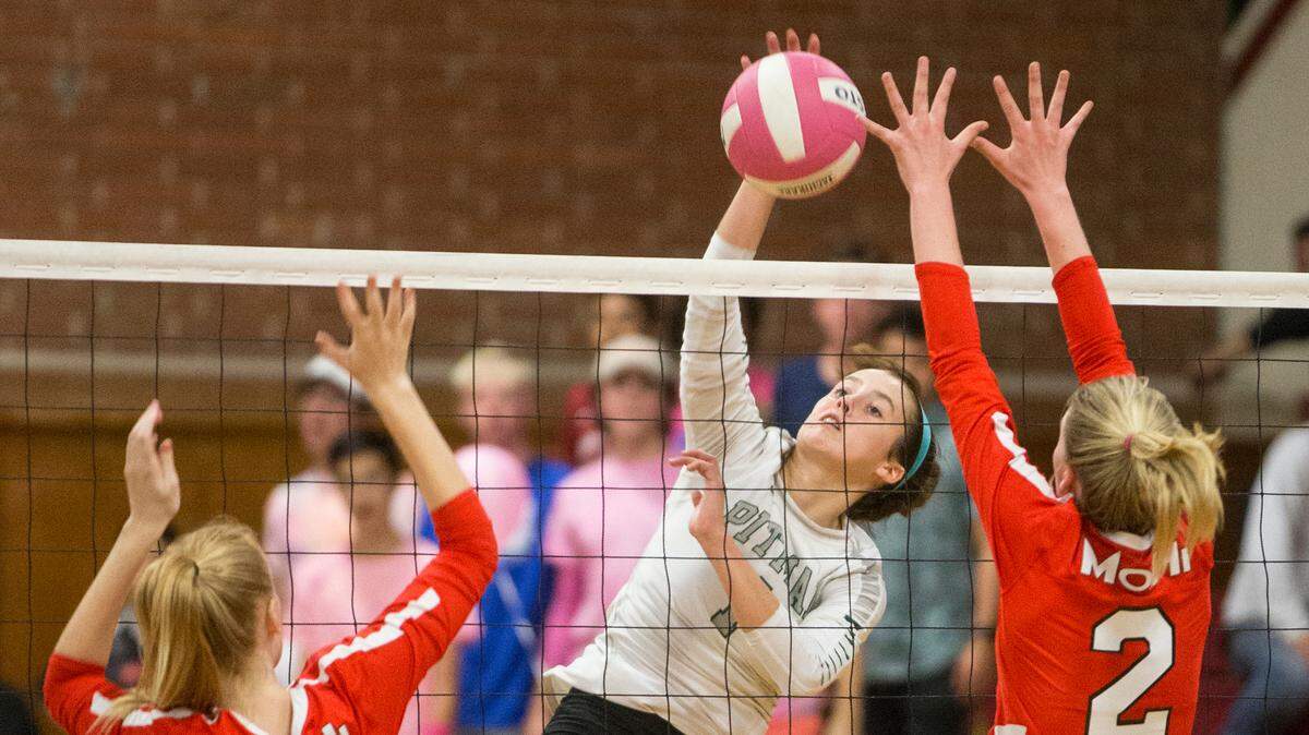 Cierra Verdone of Pitman High spikes the ball between Modesto blockers Alyssa Cover, 2, and Sara Thornberry during their match against Pitman High Monday Oct. 1, 2018. 