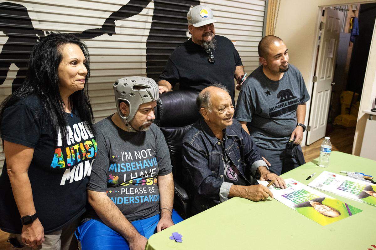 Cheech Marin of Cheech & Chong fame came to Jayden’s Journey cannabis dispensary for Epilepsy Awareness Day in Modesto, Calif., on Friday, March 25, 2022. Teresa Covarrubias, left, brought her son, Adam Ochoa, seated, who is autistic and suffers from seizures to meet Marin. Andrew Ochoa, right, and John Wright also came along to see the comedy legend.