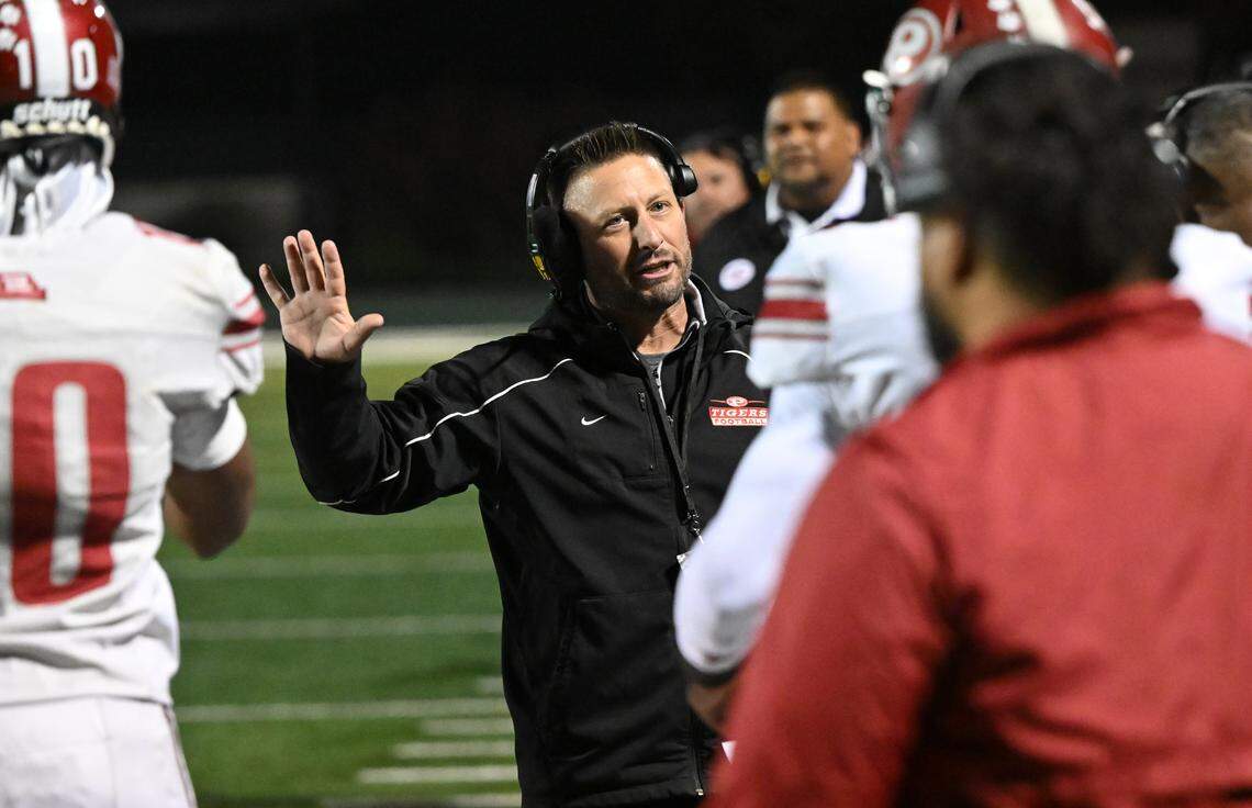 Patterson head coach Rob Cozart talks to one of his players on the sideline during the Sac-Joaquin Section Division IV championship game with Escalon at St. Mary’s High School in Stockton, Calif., Friday, Nov. 24, 2023.