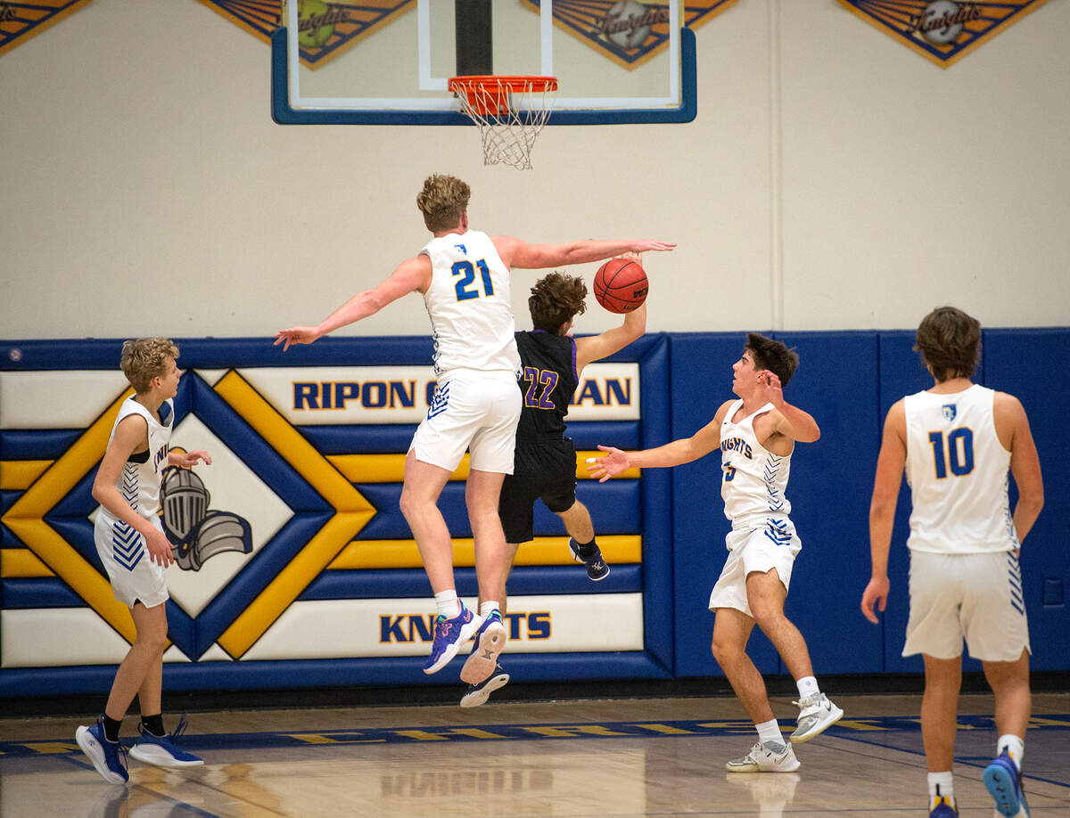 Ripon Christian’s Thys Van Der Hoek blocks Escalon’s Ben Fletcher during the Trans Valley League game at Ripon Christian High School in Ripon, Calif., on Friday, Jan. 7, 2022. Ripon Christian won the game 61-53.