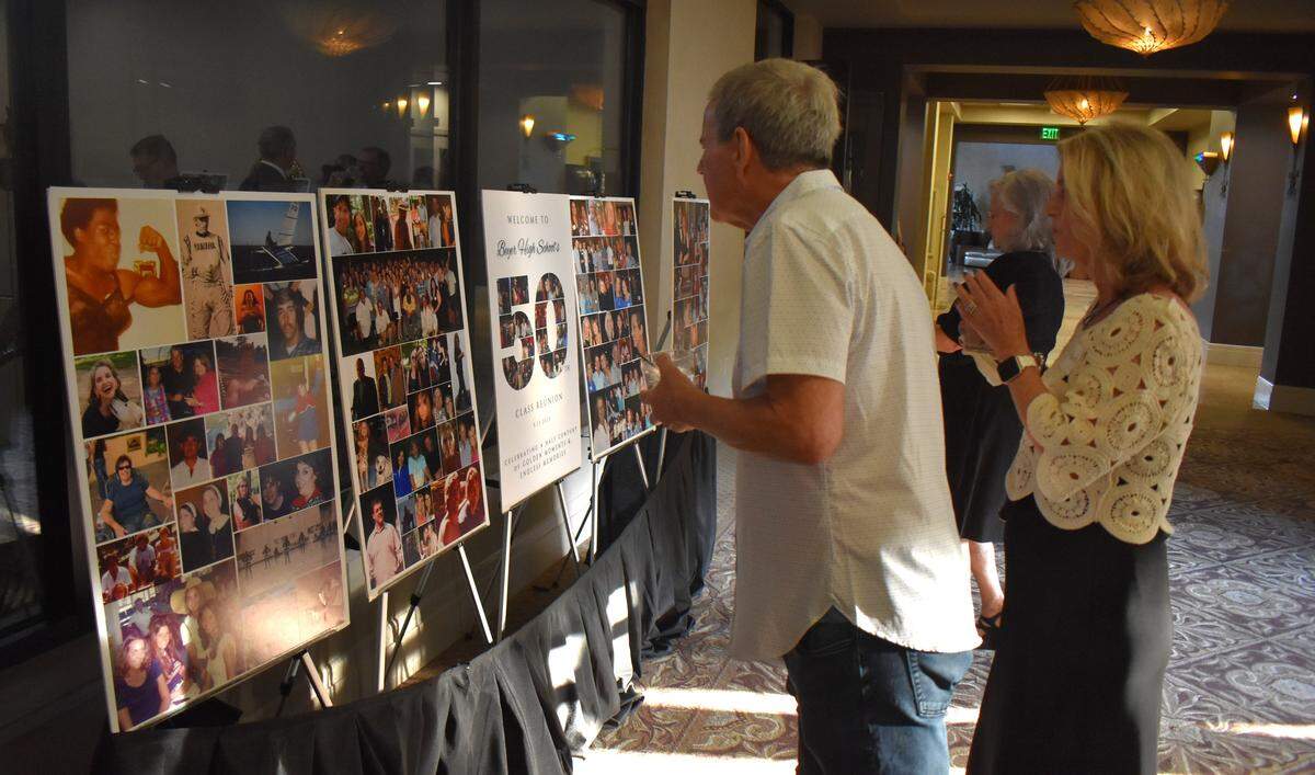 Beyer High School alumni examine photo boards at the Class of 1975’s 50-year reunion at Del Rio Country Club north of Modesto on Saturday, Sept. 13, 2025.