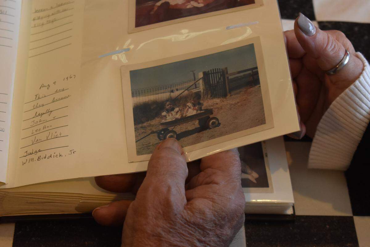 Tony Cardoza and his daughter Jo Ann look at a photo taken in 1967 on the day the twins officially became Jo Ann and Lee Ann Van Vlietduring a family lunch at Shorty’s Sports Pub & Grill in Escalon on Sunday, Nov. 24, 2019.