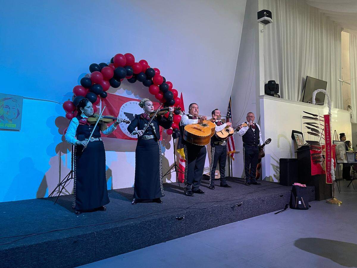 A mariachi band performs for marchers and volunteers at the Red Events Center in Modesto