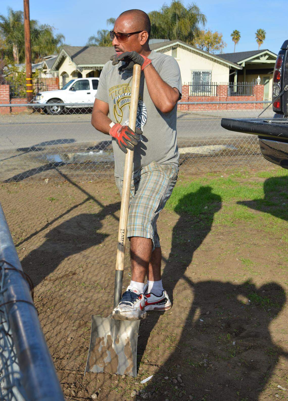 Jose Vasquez lives along a south Modesto CA street that will get sidewalks thanks to a $2.38 million state grant. He said on Dec. 6, 2022, that he shovels soil from his front yard to fill puddles along Glenn Avenue after rain.
