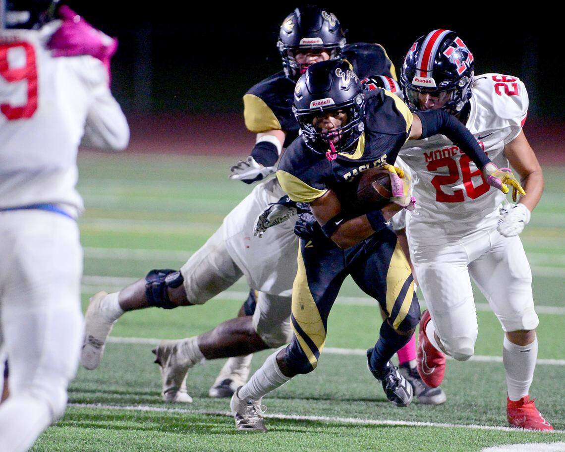 Enochs running back Eric Myles (8) runs away from multiple defenders during a game between Modesto High School and Enochs High School at Gregori High School in Modesto, CA on October 4, 2024.