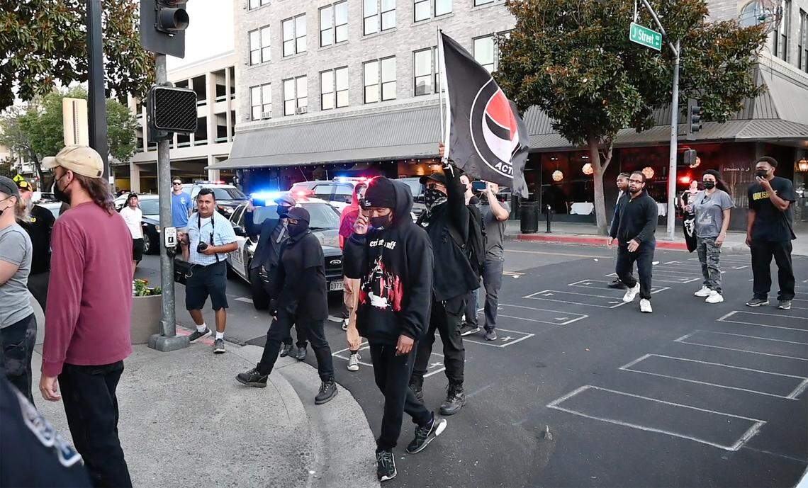 Members of the Proud Boys and opposing groups were separated by police on 11th Street after Tuesday’s Modesto City Council meeting in Modesto, Calif., on Tuesday, June 22, 2021.