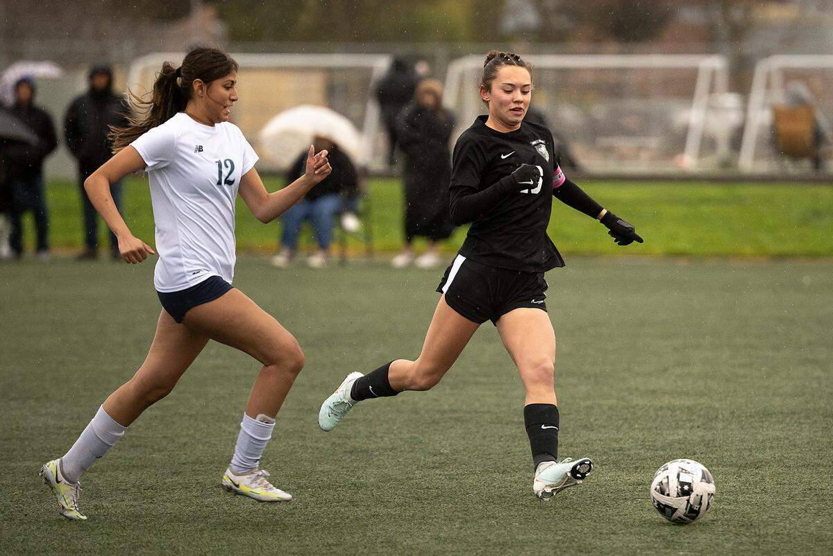 Enochs’ Kaytlynn Nice, right, tracks down the ball as Downey’s Camila Gomez defends in the California Athletic League match in Modesto, Tuesday, Feb. 4, 2025. Enochs won the match 3-1. 
