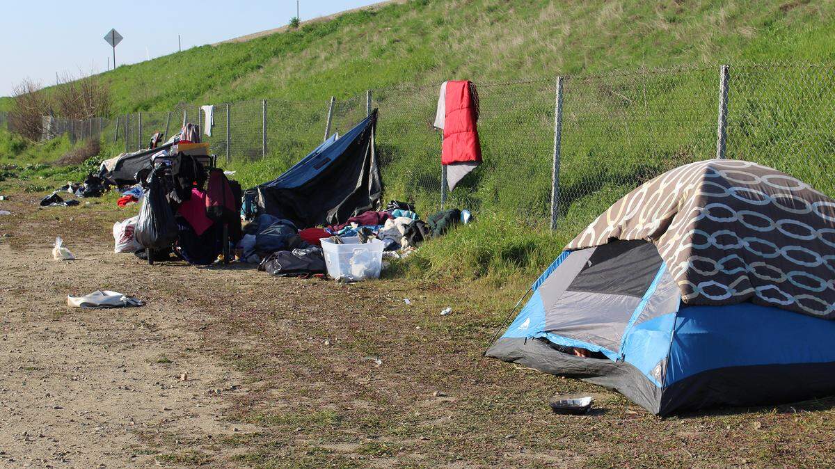 Tents line a Highway 99 off-ramp in Turlock, Calif., on Feb. 4, 2022. The city is continuing a local unsheltered homeless crisis declared in July 2021.