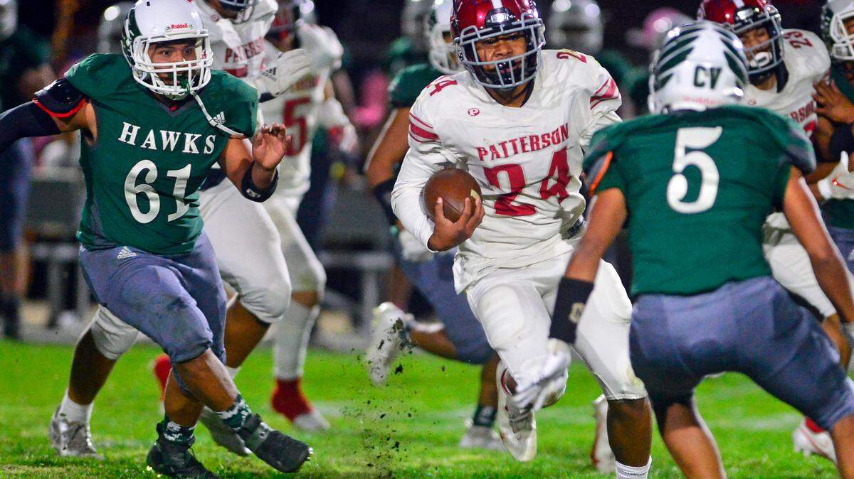 Patterson running back Lolo Mataele (24) runs through the Central Valley defense during a game between Patterson High School and Central Valley High School at Ceres High School in Ceres California on October 8, 2021.