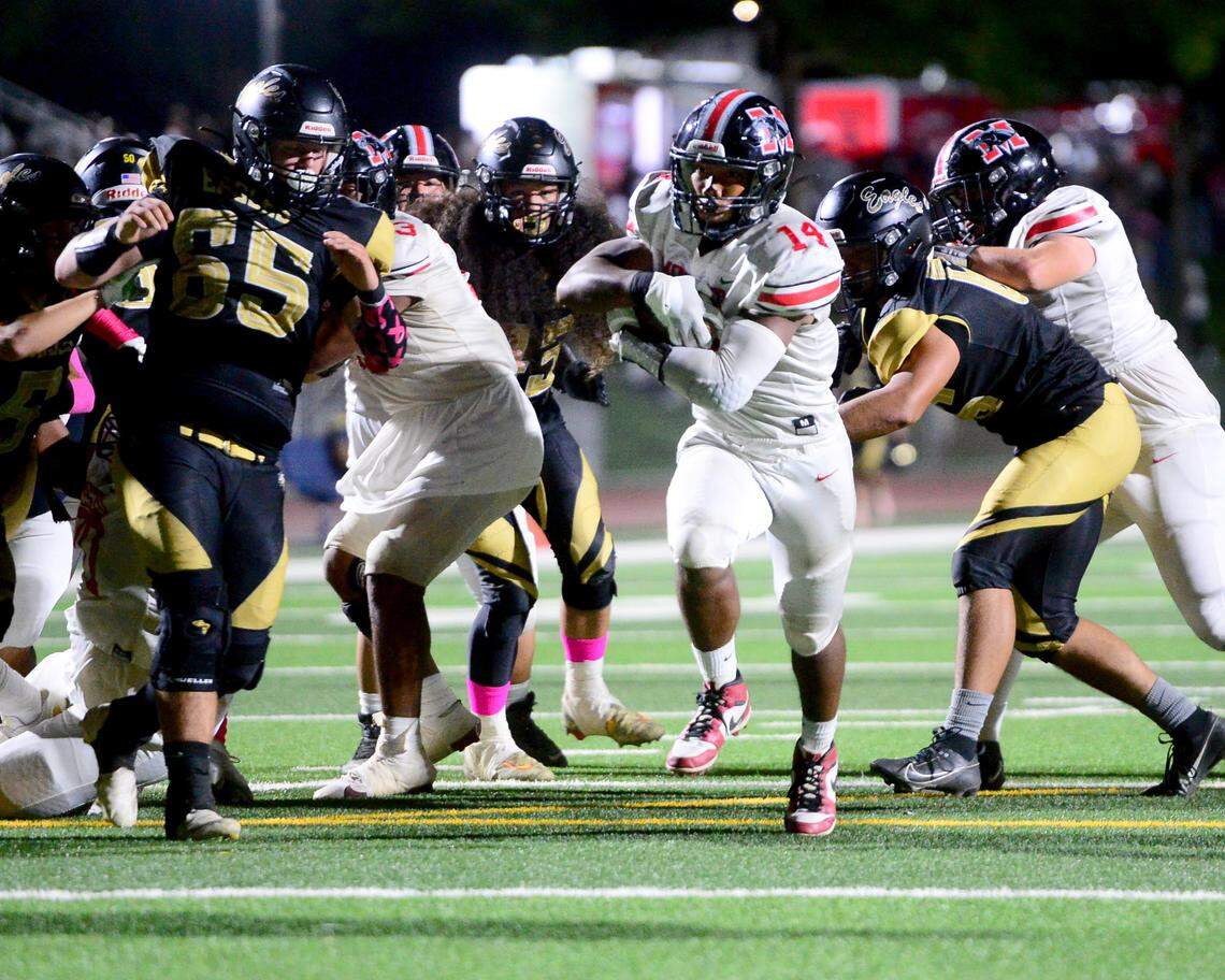 Modestos Vanntheesouk ‘Lucky’ Dam (14) runs up the middle to score a touchdown during a game between Modesto High School and Enochs High School at Gregori High School in Modesto, CA on Oct. 4, 2024.