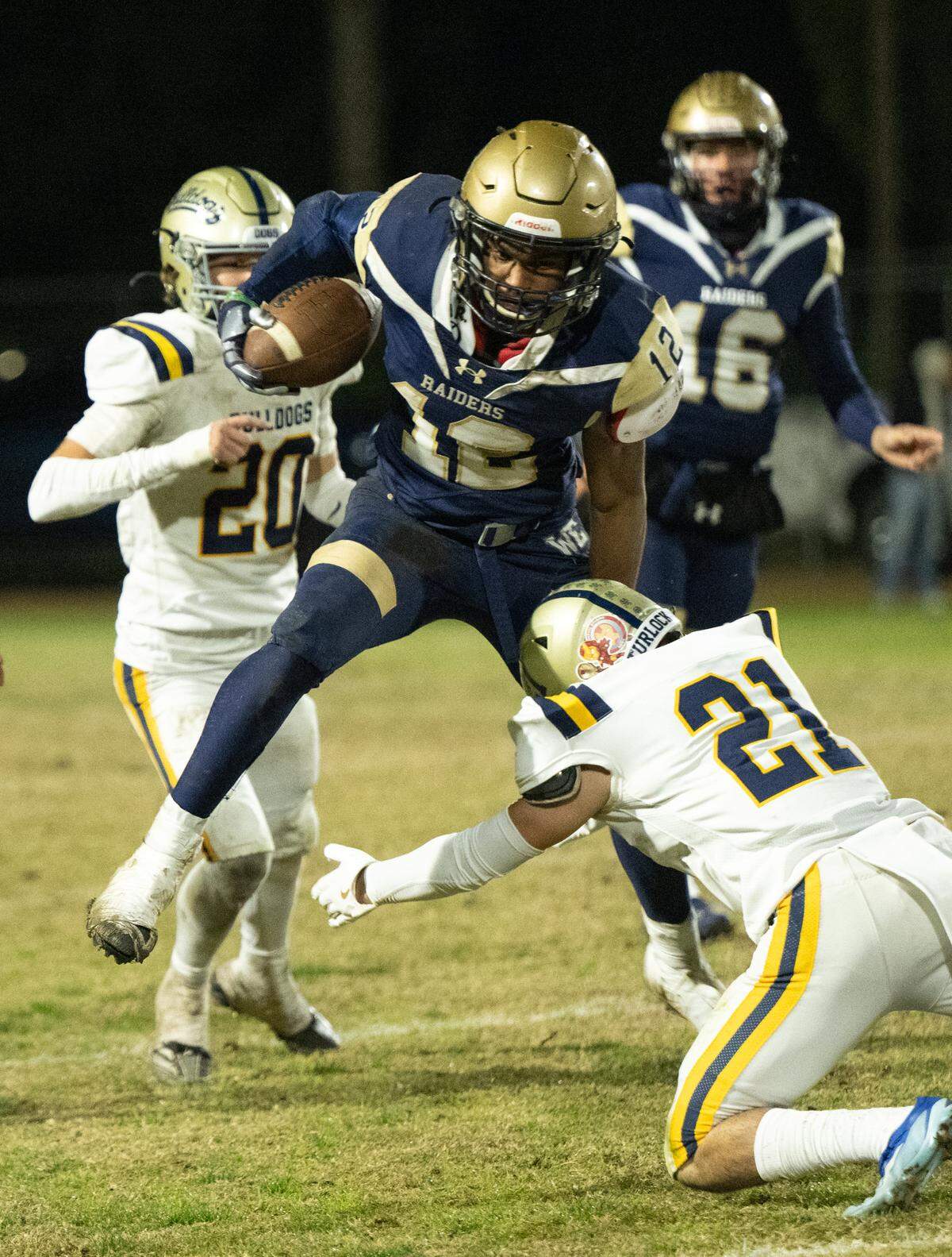 Central Catholic’s Joey Alcutt hurdles Turlock defender Mateo Valencia during the Sac-Joaquin Section Division I playoff game at Central Catholic High School in Modesto, Friday, Nov. 15, 2024.