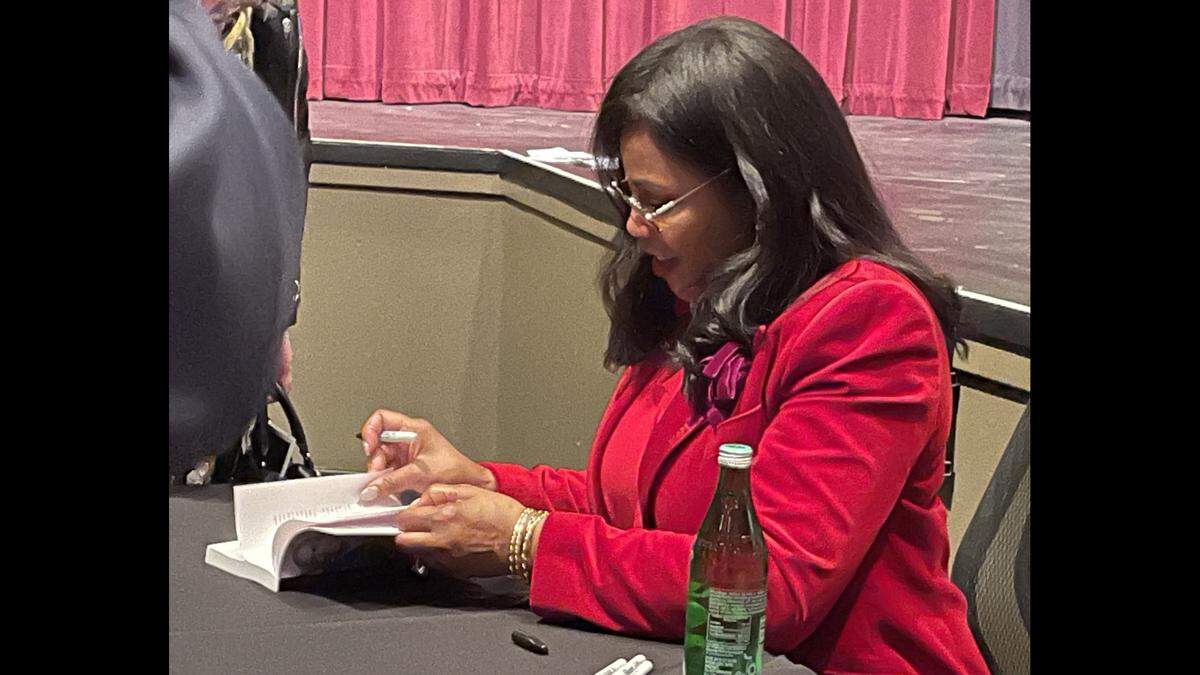 Ilyasah Shabazz, daughter of slain civil rights leader Malcolm X, signs one of her books after speaking at Modesto Junior College on Feb. 7, 2026.