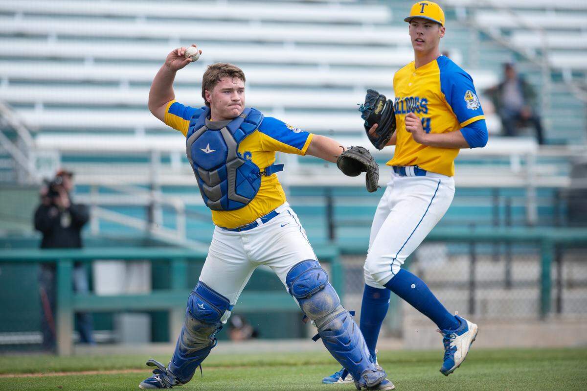 Turlock catcher Owen Miller fields a bunt and throws out a runner during the game with Enochs at John Thurman Field in Modesto, Calif., Friday, March 31, 2023.