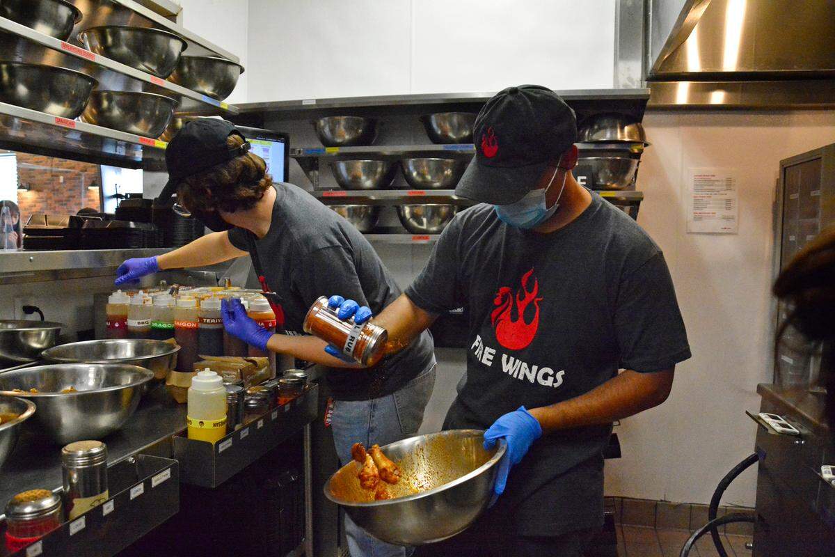 Joel Lizama prepares an order of wings at the new Fire Wings restaurant in Modesto, Calif.