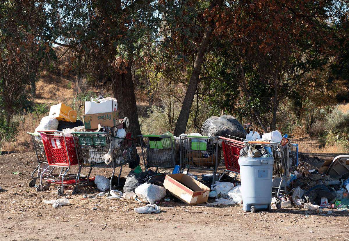 Garbage and other debris is piled up near the Mitchell Road bridge in the Tuolumne River Regional Park in Modesto, Calif., on Wednesday, September 21, 2022.