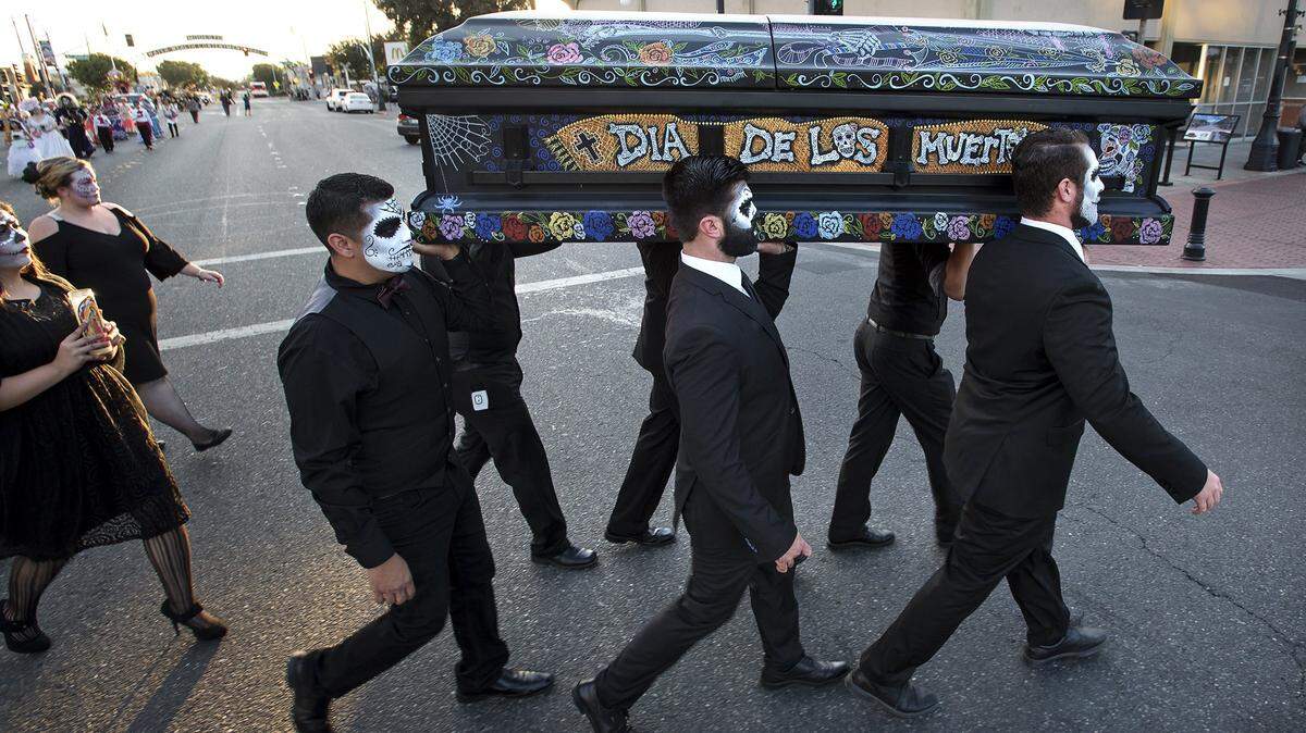 The ceremonial casket is carried during a previous year’s Dia de los Muertos procession in downtown Modesto.