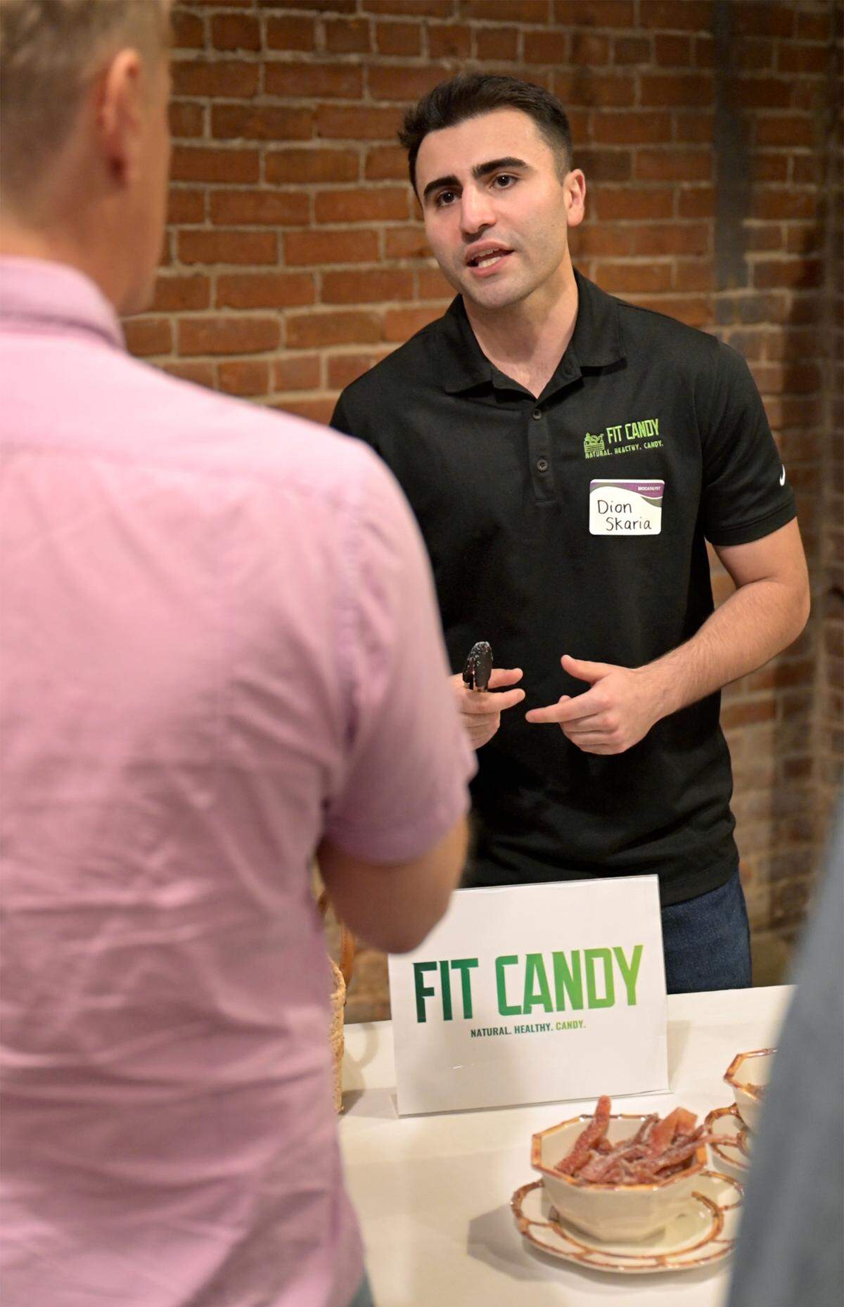 Dion Skaria talks with guest about his candy made from watermelon rinds during the BEAM Circular Accelerator showcase at The River Mill near French Camp on May 22, 2025.