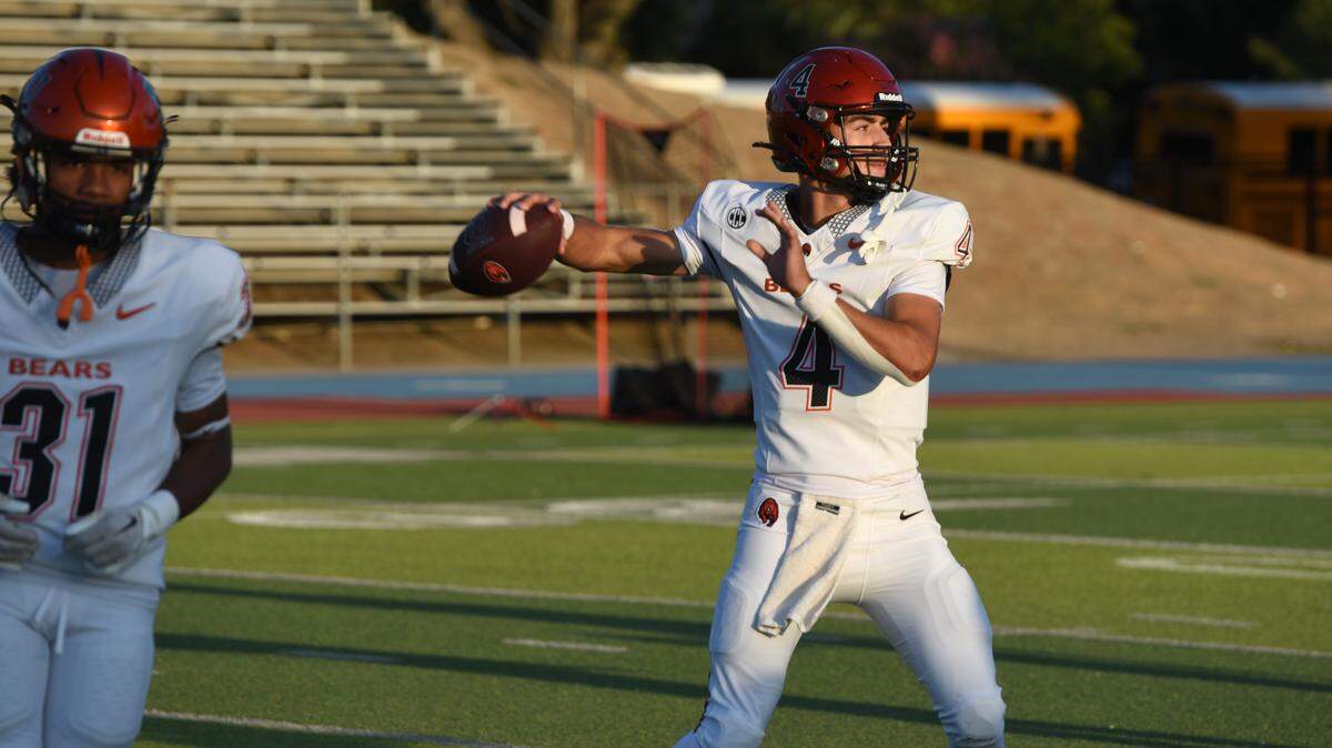 Merced quarterback Vicente Cortez warms up in the game with Downey at Downey High School in Modesto, Friday, Sept. 5, 2025.
