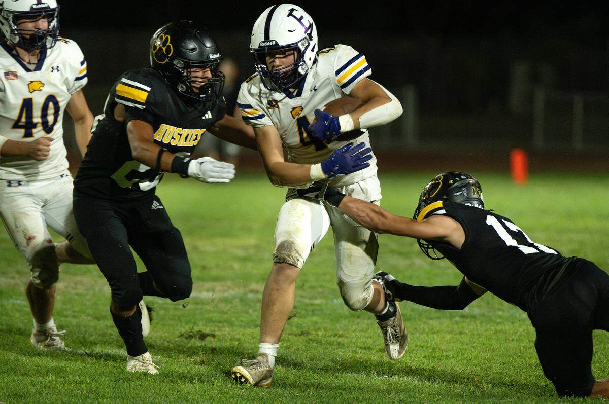 Escalon’s Dylan Ball runs the ball during the Trans Valley League game with Hughson in Hughson, Calif., Friday, Oct. 4, 2024.