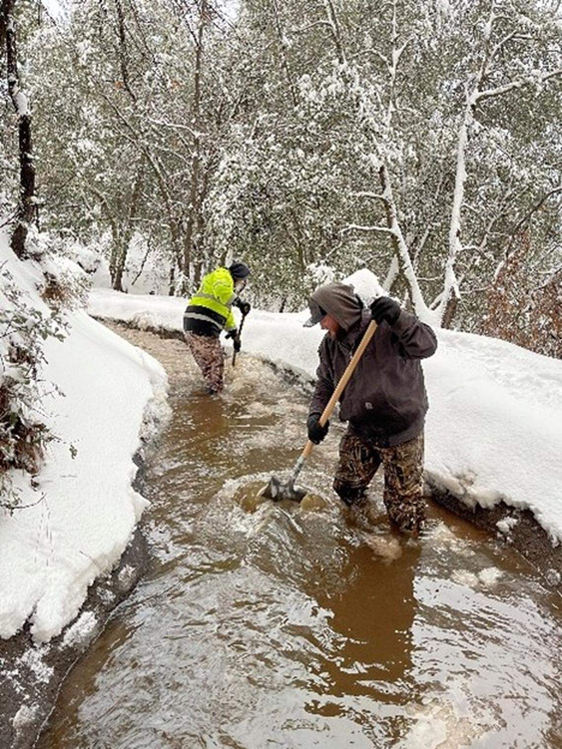 A crew with the Tuolumne Utilities District does winter maintenance on one of the canals that carry water to Sonora and nearby areas.