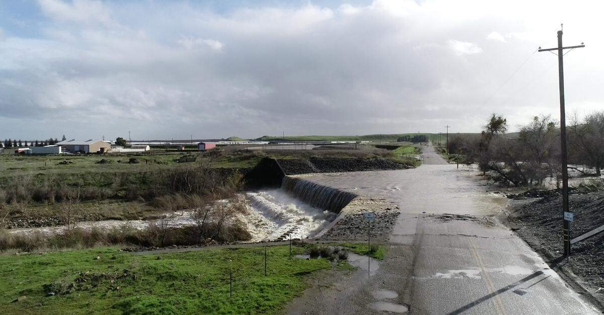 Orestimba Creek floods Bell Road on Stanislaus County’s West Side on Tuesday, Jan. 10, 2023.
