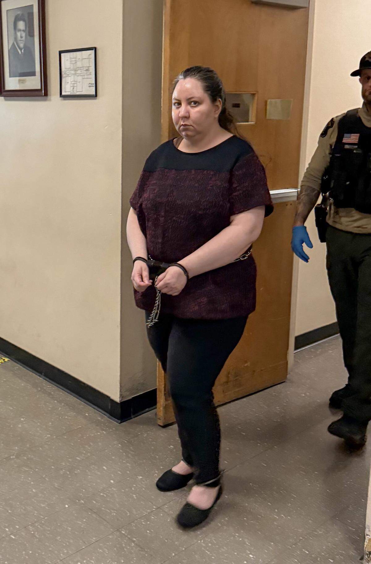 Mina Nazari, 36, is escorted out of a Stanislaus County courtroom after a jury found her legally sane in the killing of her 4-year-old daughter and the attempted murder of her son.