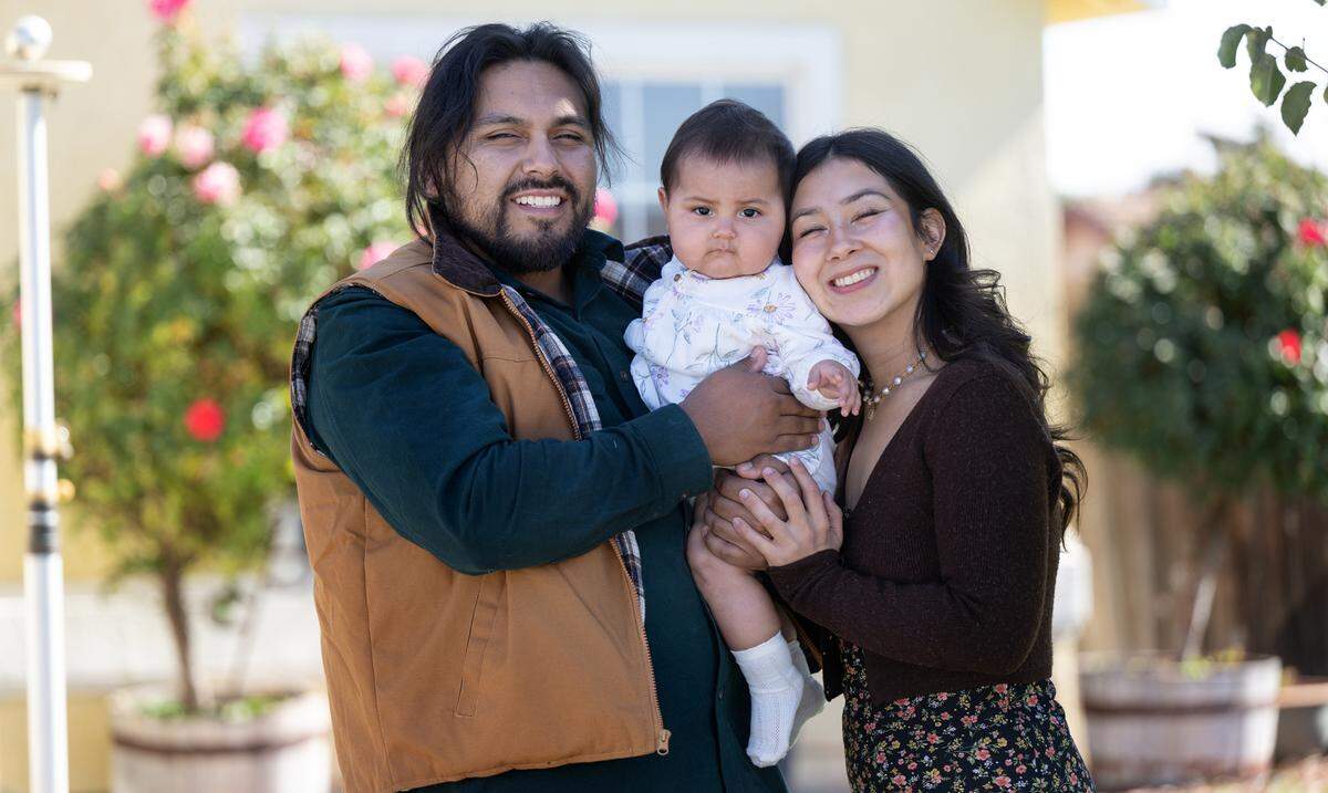 Gisel Tafolla with her seven-month-old daughter Sophia Belen and her husband Jesus Estrada at their home in Delhi, Thursday, Oct. 24, 2024. In July, Gisel had postpartum cardiomyopathy, experienced cardiogenic shock and a small heart pump was needed to save her life.