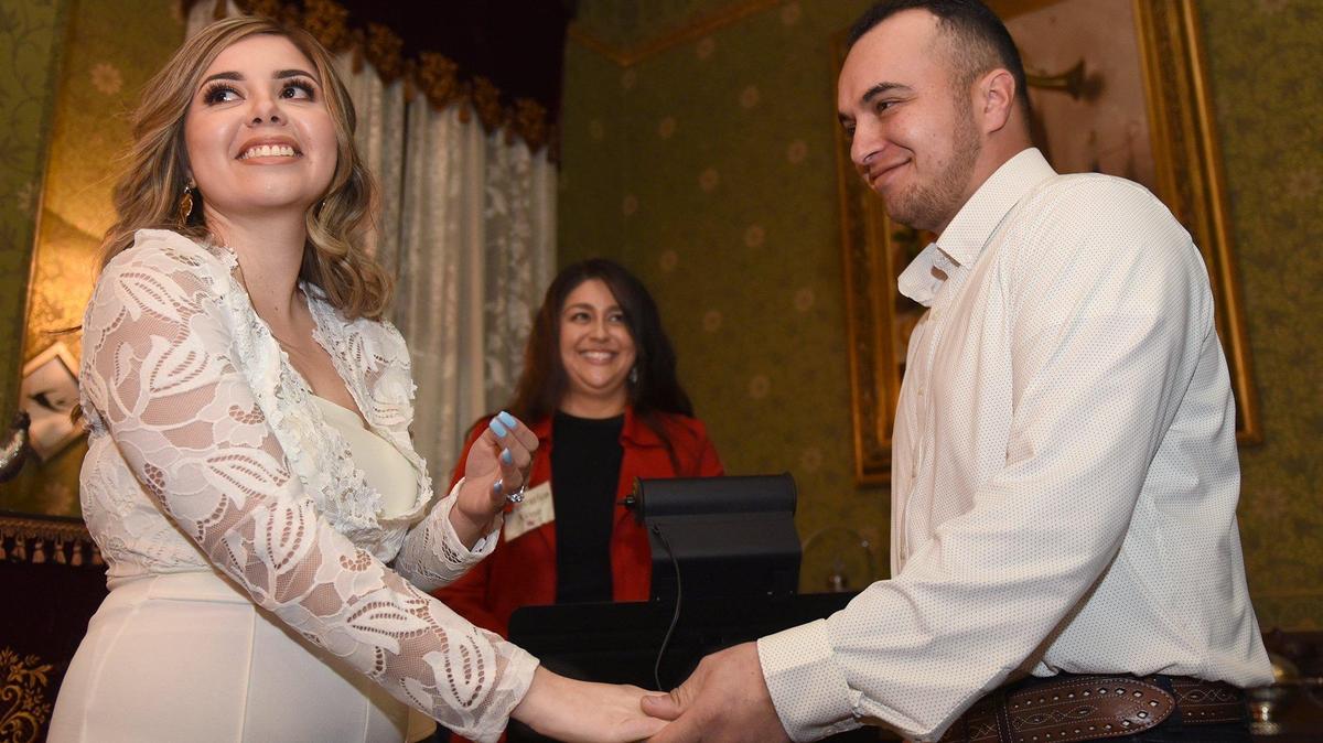 Laura and Francisco Chavez of Delhi, Calif. smile at their families after getting married Thursday February 14, 2019 at the McHenry Mansion in downtown Modesto.
