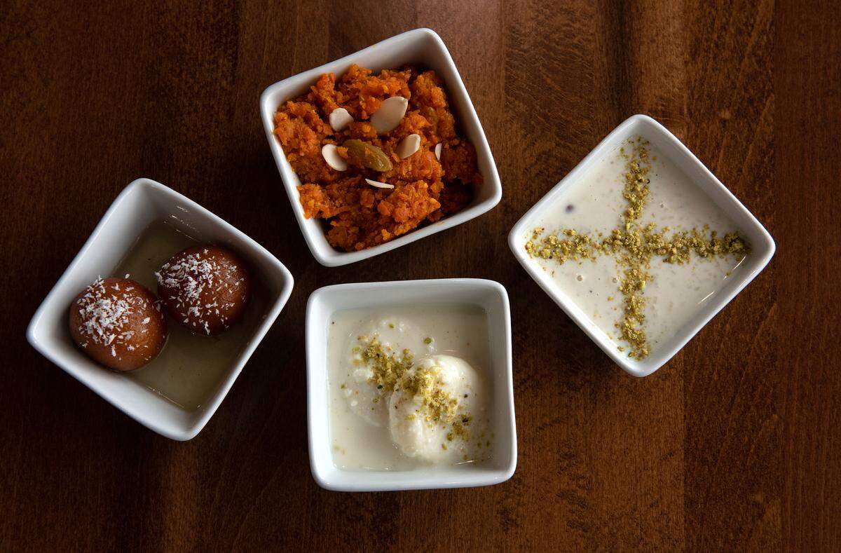 Four deserts are offered at Tandoori flame restaurant in Patterson, Calif., on Friday, April 22, 2022. From the left, Gulab Jamun (dumplings in sugar syrup) Gajar Halwa (grated carrots with nuts), Kheer (rice pudding with cardamom and almonds) and Rasmali (spongy was dipped in malai cream)
