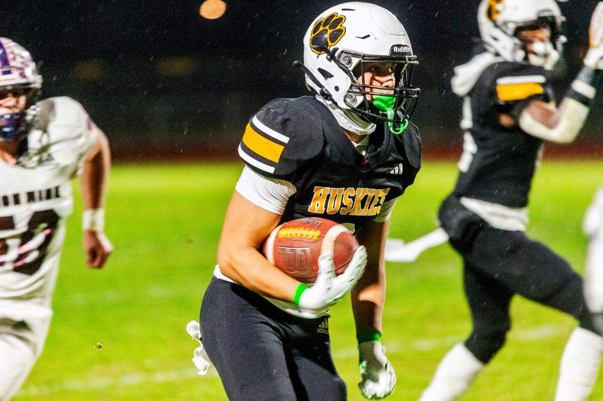 Lawson Aviles, 3, of Hughson High runs upfield as Union Mine closes in during the Sac-Joaquin Section Division V Semifinals against Union Mine on at Hughson High School on Friday, Nov. 22, 2024.