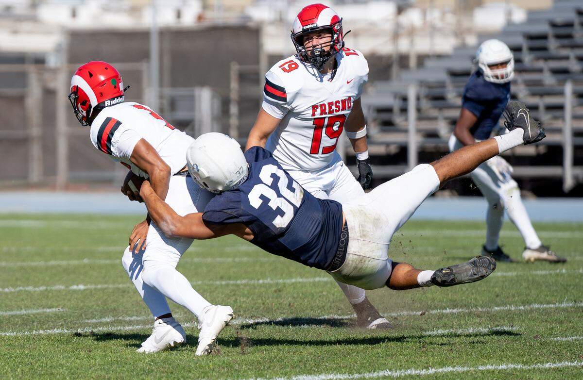 Modesto JC defensive lineman Jalonn Booth sacks Fresno City College quarterback Christian English during a Valley Conference game at Modesto Junior College on Saturday, Oct. 11, 2025.