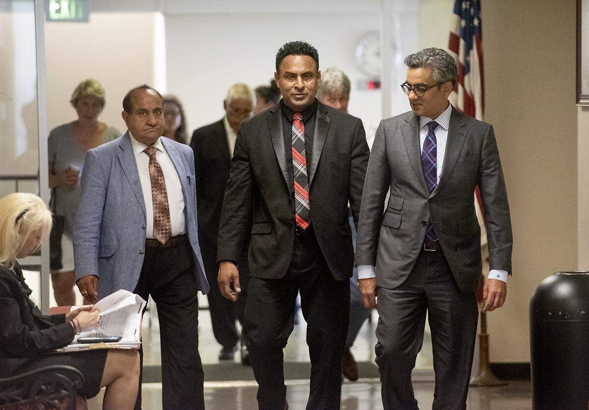Daljit Atwal, middle, arrives at the Stanislaus County Superior Courthouse with attorney Jai Gohel, right, in Modesto, Calif., Friday, June 14, 2019.
