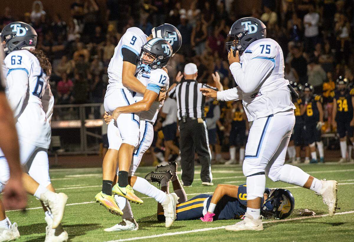 Downey kicker Elijah Reyneveld (9) and Gabe Hernandez (12) celebrate a game winning field goal over Turlock during the Central California Athletic League game in Turlock, Calif., Friday, Oct. 7, 2022. Downey won the game 24-22.