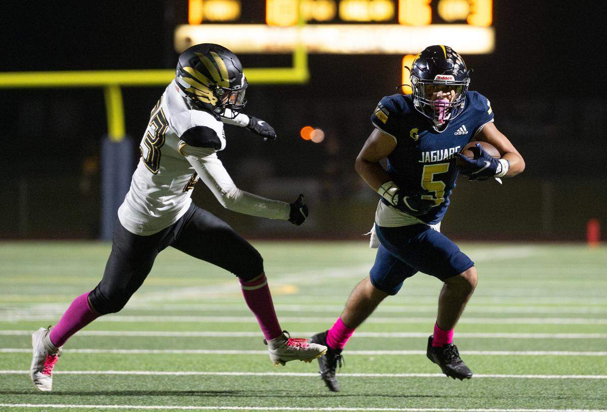 Gregori’s Landon Gutierrez runs past Enochs’ Christian Del Toro Bazan during the Central California Athletic League game at Gregori High School in Modesto, Calif., Friday, Oct. 6, 2023.