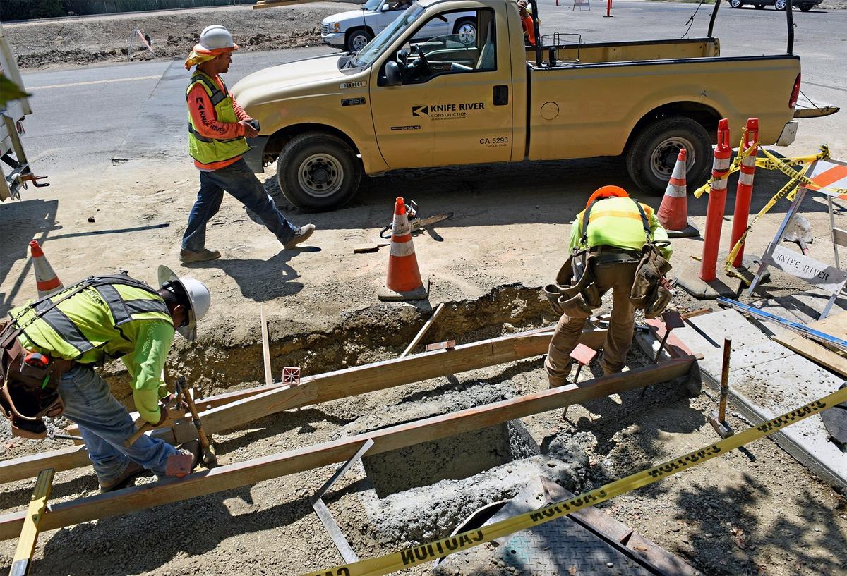 FILE PHOTO - Construction crews with Knife River work on a sidewalk on Chicago avenue at Carpenter road in Modesto, Calif. on Thursday afternoon August 16, 2018. The Carpenter road  project is one of the road improvements in Modesto funded by sales tax revenue from voter-approved Measure L.