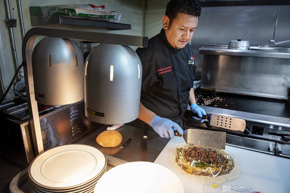 Owner and chef Miguel Martinez prepares a burrito at Delicioso Restaurant on H Street in Modesto, Calif., on Wednesday, Feb. 19, 2020.