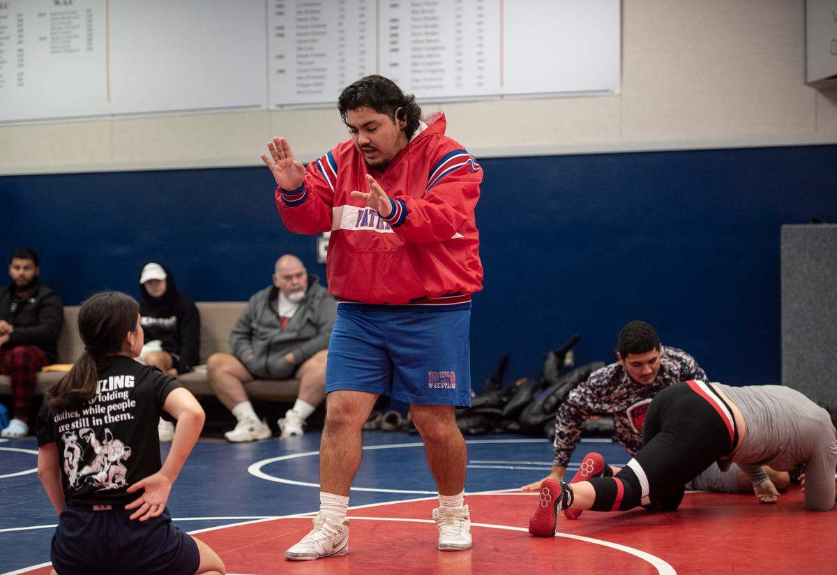 Coach Ken Severe talks with members of the wrestling team during practice at Beyer High School in Modesto, Calif., on Monday, Dec. 20, 2021.