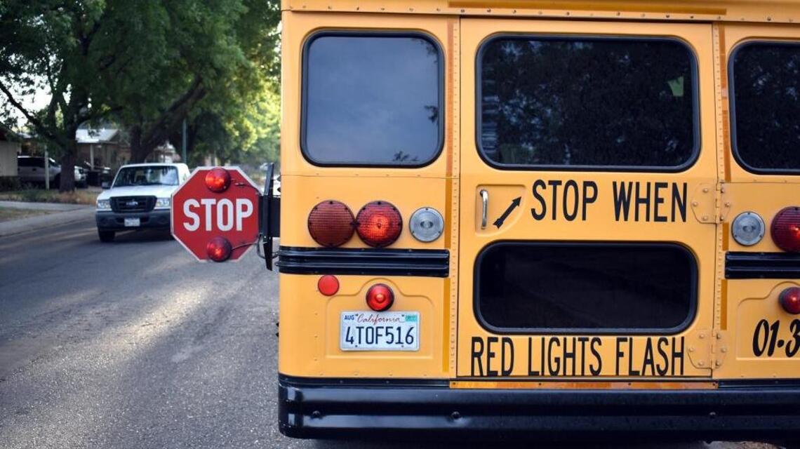 Will I get a ticket for going around a stopped school bus? What CA law says