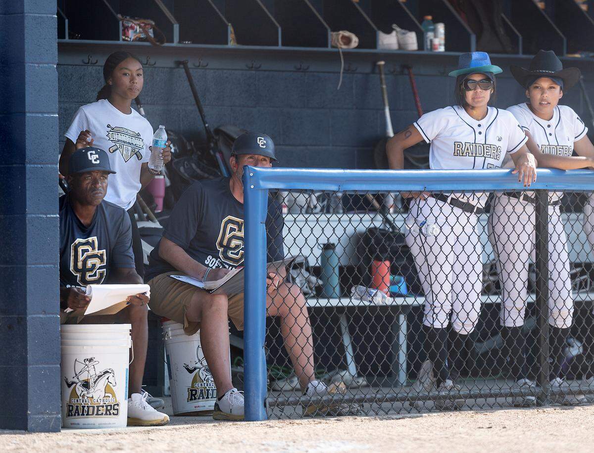 Central Catholic coach Sam Nichols, left, watches the defense during the CIF Sac-Joaquin Section Softball semifinal playoff game with Oakdale at Central Catholic High School in Modesto Calif., on Tuesday, May 24, 2022.
