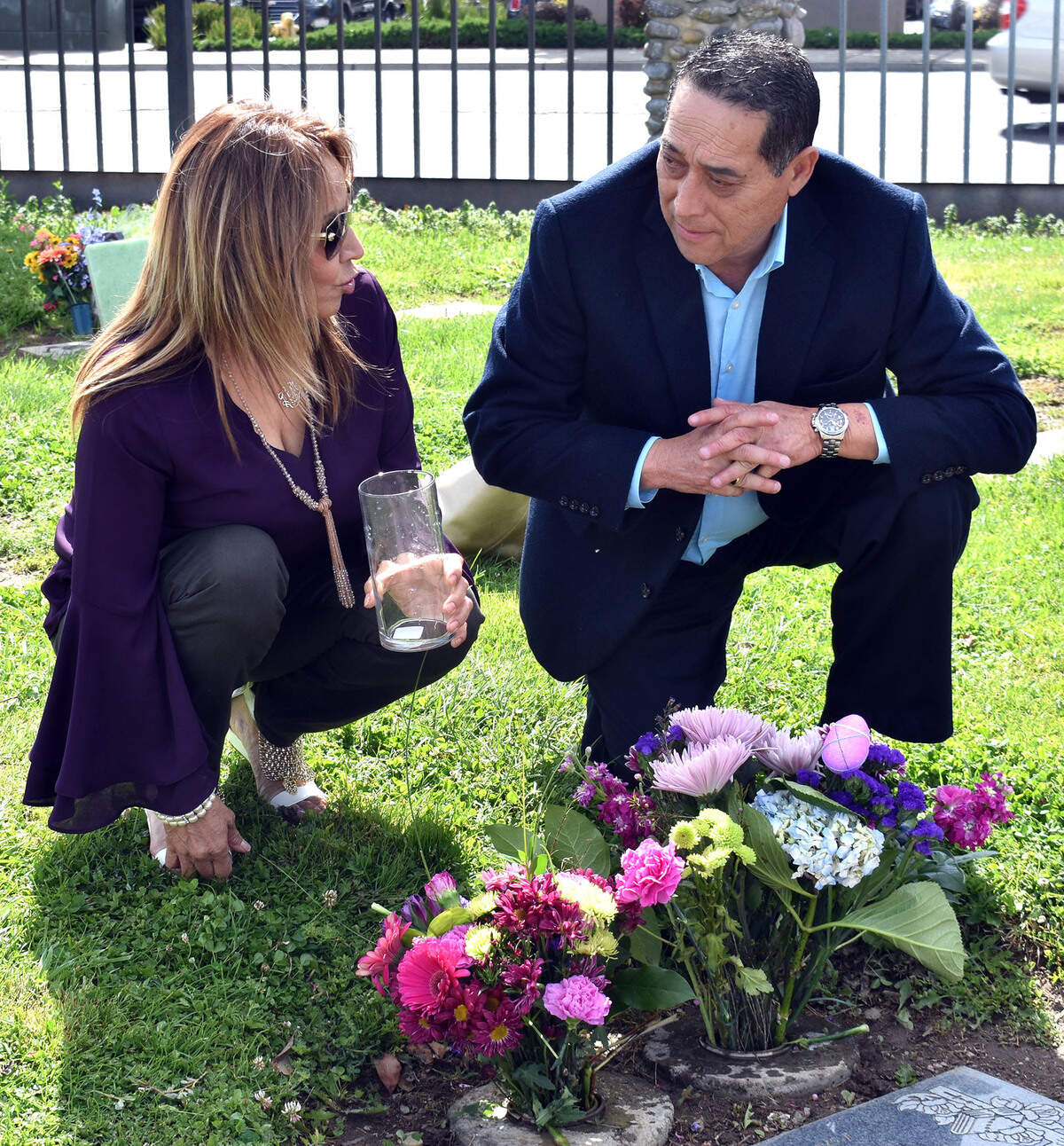 Julie Sandoval and Ramiro Cruz talk after placing flowers at the grave of Julie’s son Erik in St. Stanislaus Catholic Cemetery on Scenic Drive on Tuesday morning, April 16, 2019, in Modesto.