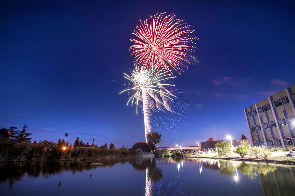 Fireworks tower above at California State University, Stanislaus in Turlock, Calif., on Saturday, July, 4, 2015.
