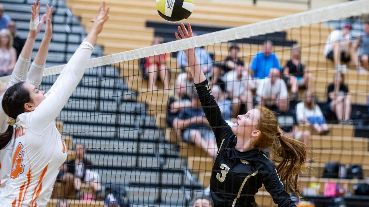 Lexie Hall, 3, tips a ball over the net as Madison Rodriguez of Kimball goes for the block during their non league volleyball match at Enochs High Tuesday Sept. 03, 2019.