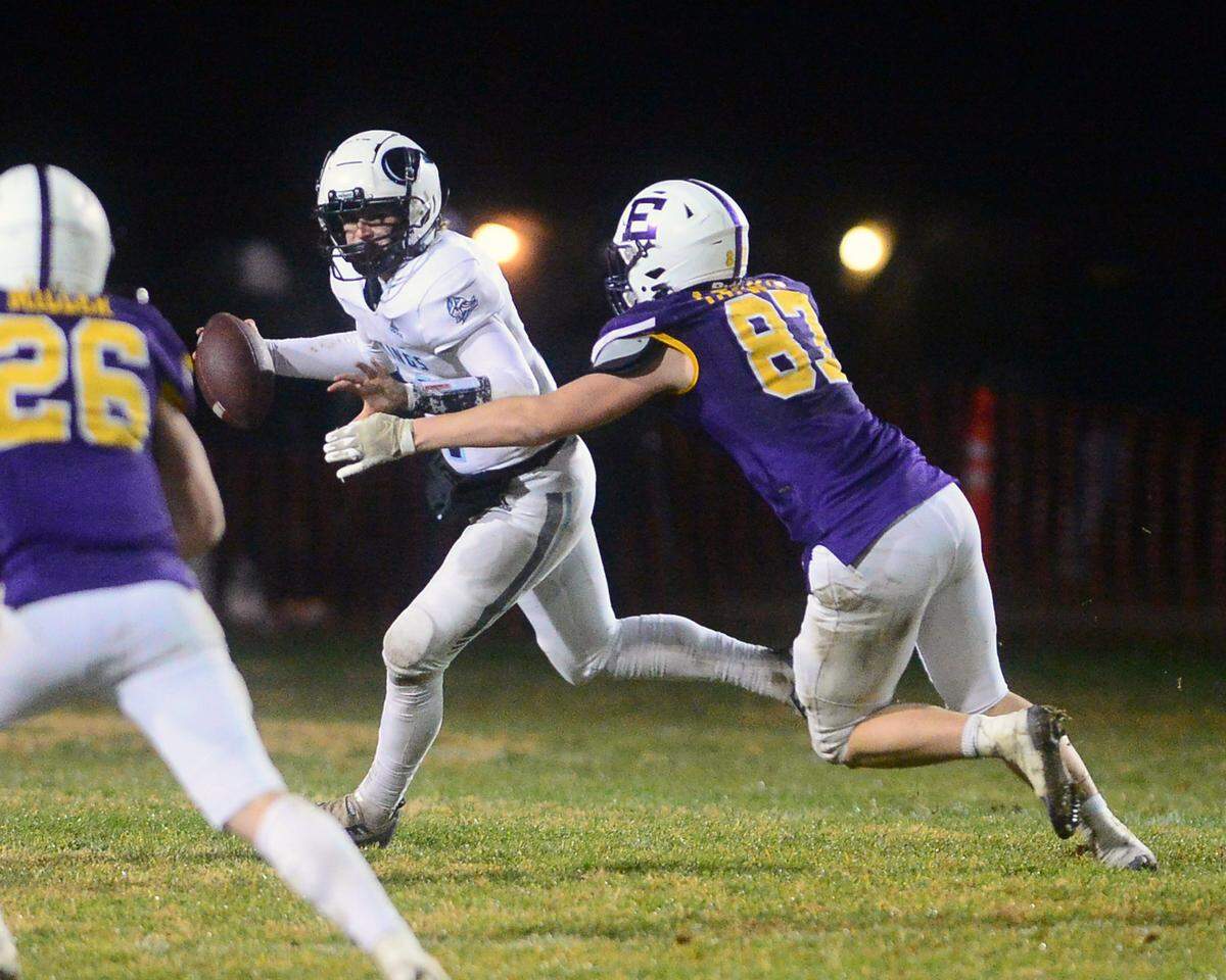 Pleasant Valley quarterback Elijah Sanchez scrambles away from Escalon defender Ryan Lewis during the 2022 CIF NorCal Division 4-AA Bowl Game between Escalon High School and Pleasant Valley High School at Escalon High School in Escalon CA on Dec. 2, 2022. Escalon won the game 42-20.