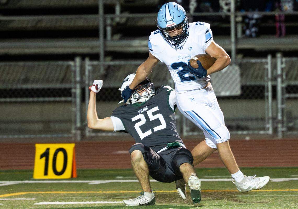 Downey’s Bryant Mendes fights off Pitman’s Dante Jenkins on a touchdown run during the Central California Athletic League game at Turlock High School in Turlock, Friday, Oct. 10, 2025. Downey won the game 28-0.