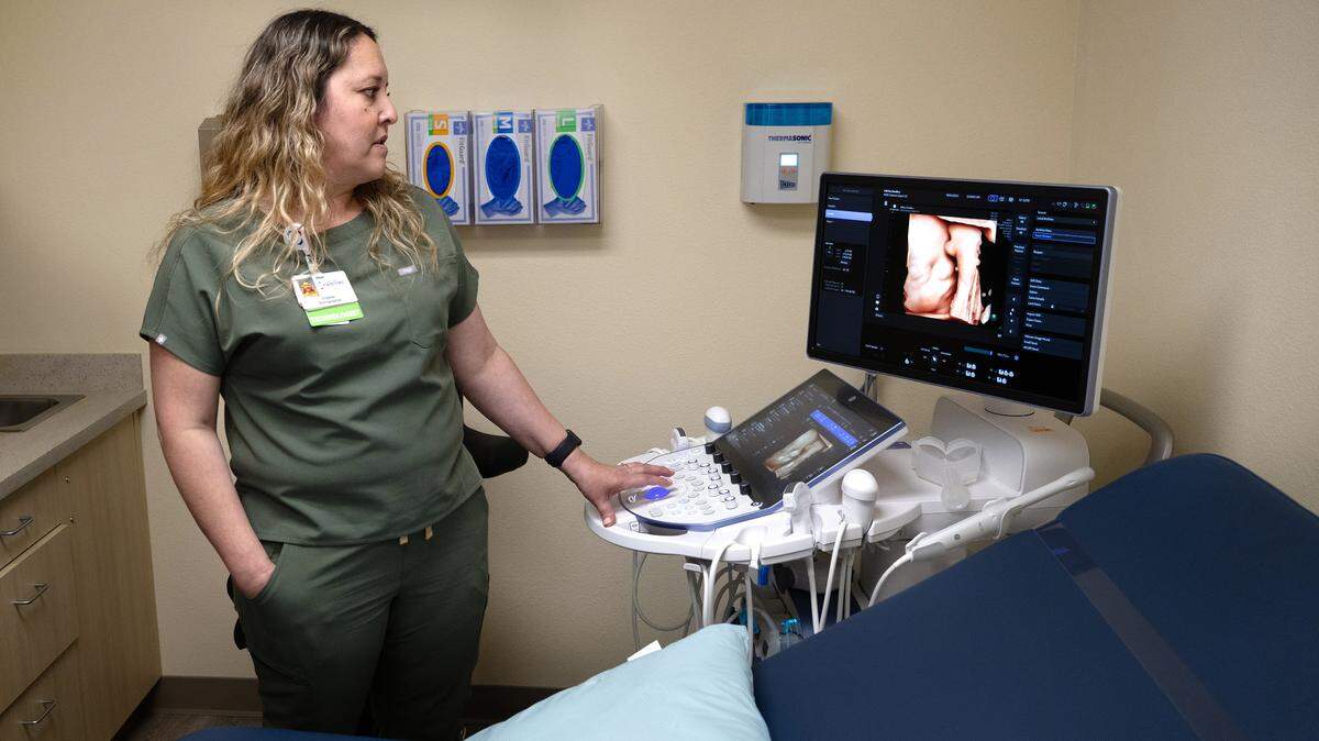 Sonographer Crystal Alvarez demonstrates imaging equipment in the ultrasound exam room at the Maternal Fetal Medicine clinic in Modesto on Monday, April 14, 2025.