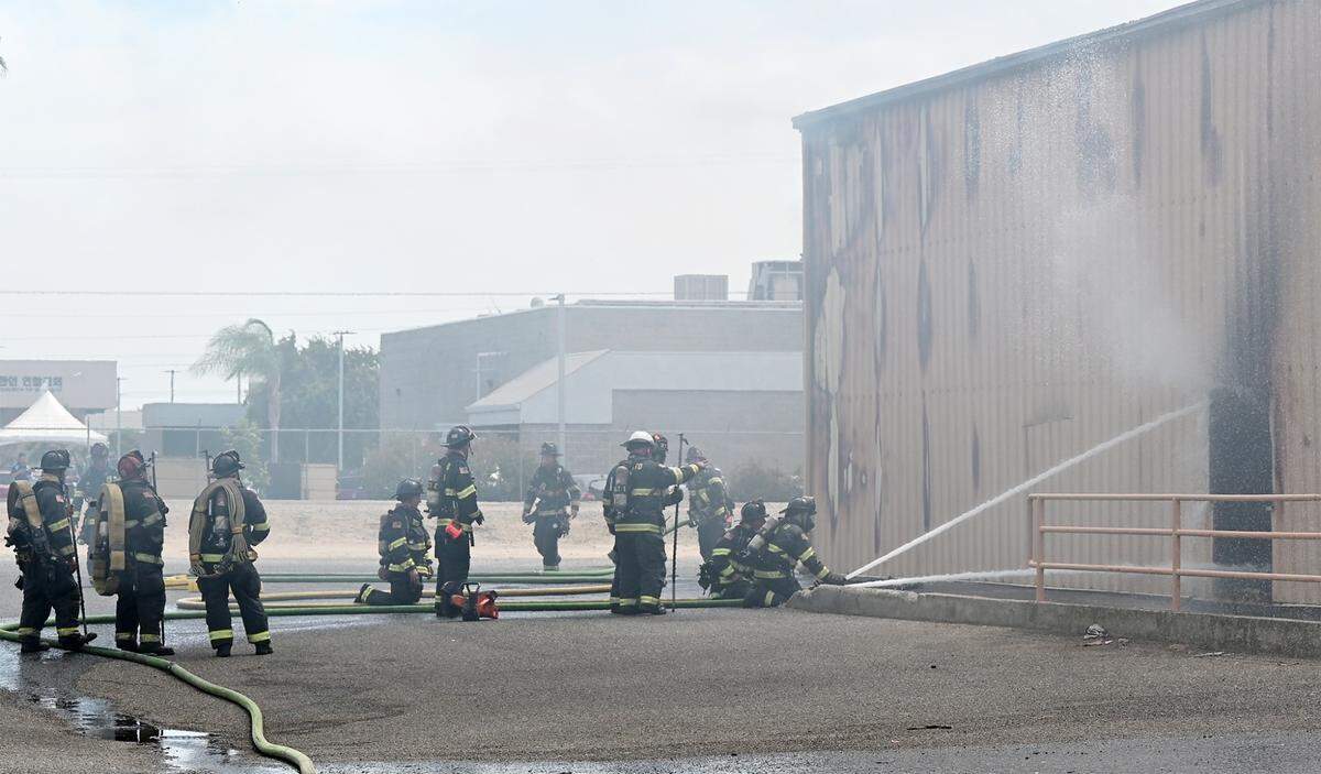 Firefighters battle a blaze at The Salvation Army Family Thrift Store and Donation Center on McHenry Avenue at Bangs Avenue in Modesto, Calif., on Thursday, June 2, 2022.
