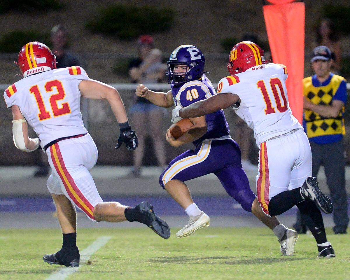 Escalon fullback Jeremy Grivette (40) looks back at two Oakdale defenders during a game between Escalon High School and Oakdale High School in Escalon, Calif. on Sept. 6, 2024. Oakdale won the game 21-20 in overtime.
