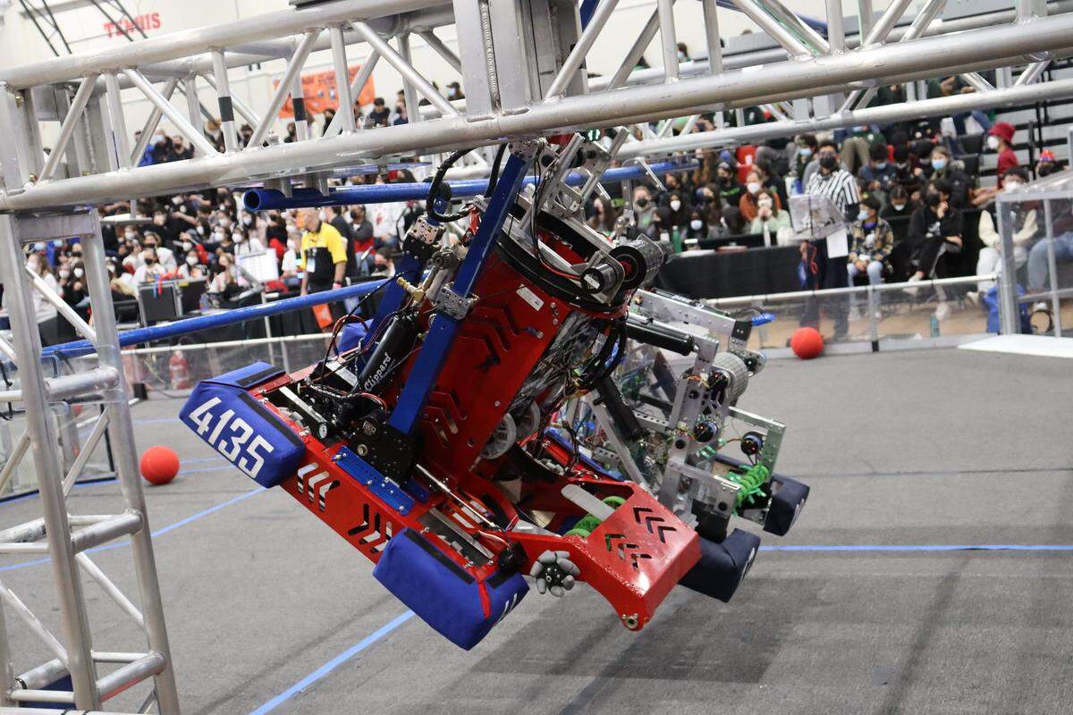 The Iron Patriots’ robot climbs to the third bar in the end game to score valuable ranking points.