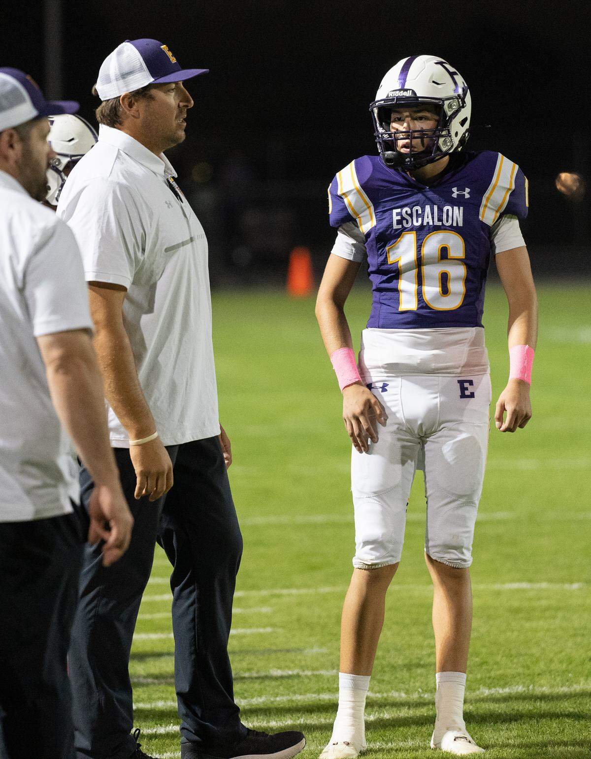 Escalon quarterback Donovan Martinez talks with head coach Andrew Beam during a non-league game against Woodland Christian at Escalon High School on Thursday, Oct. 10, 2024.