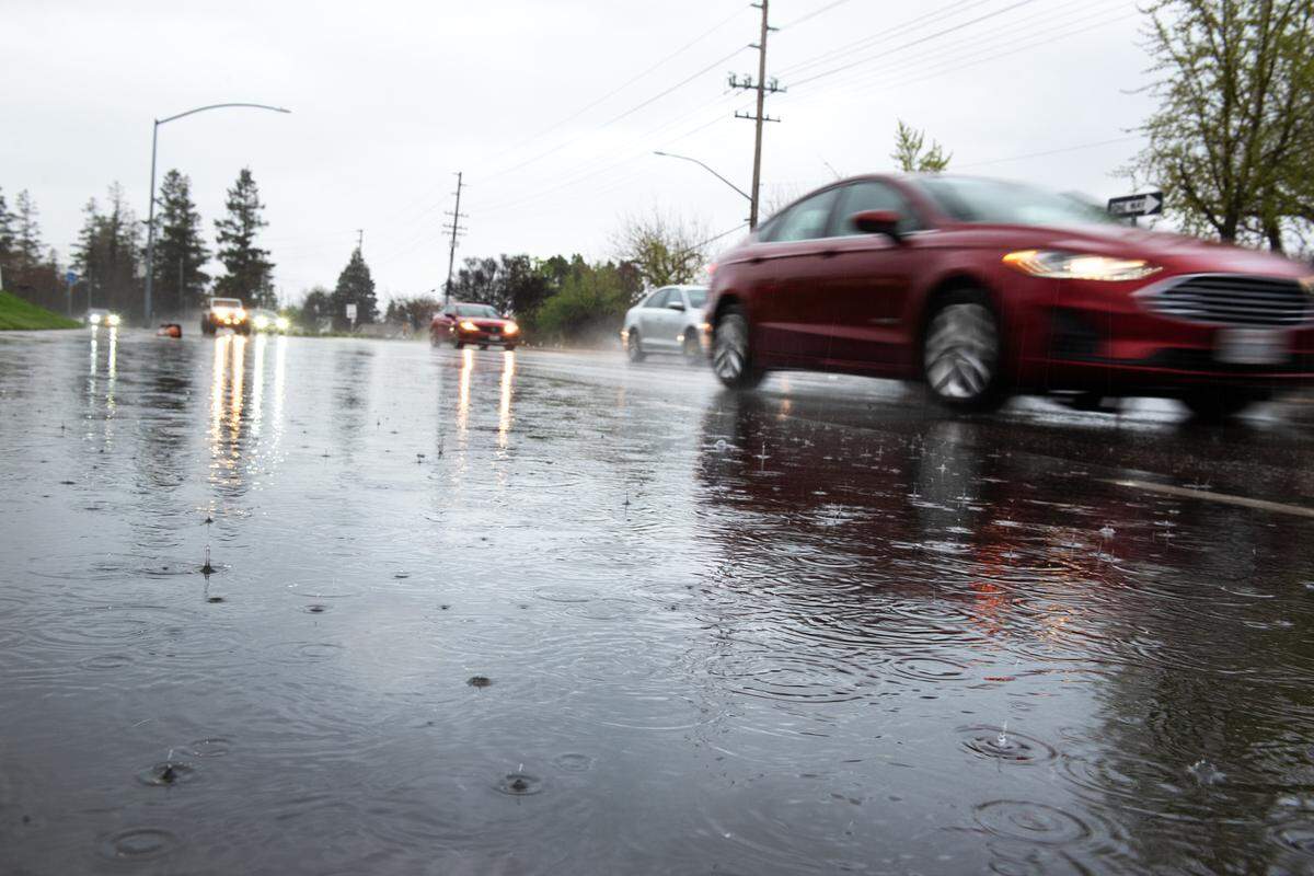 Water pools up on Standiford Avenue during heavy rain in Modesto, Calif., Tuesday, March 28, 2023. 